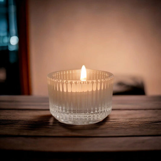 Clear glass tealight holder with minimalist design on white background