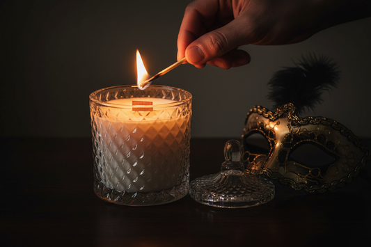The Lighting — lid off to the side, hand lighting the wooden wick