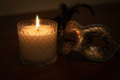 The Moment — lid off, flame reflected in masquerade mask